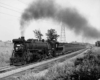 a steam engine pulling passenger cars