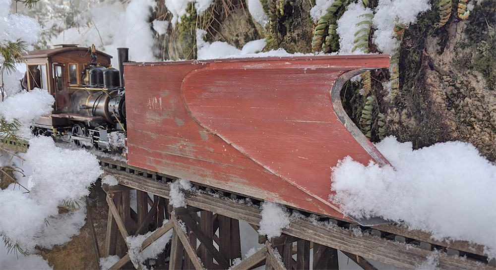 plowing snow on a garden railway