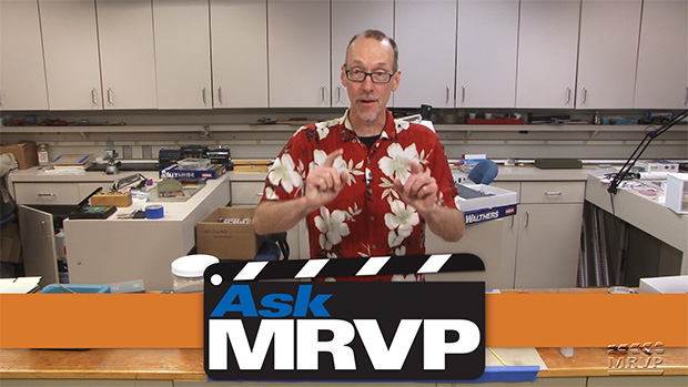 David Popp introduces a video while standing behind a counter in the Model Railroader workshop.