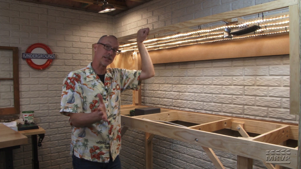 David Popp stringing LED rope lighting to his layout