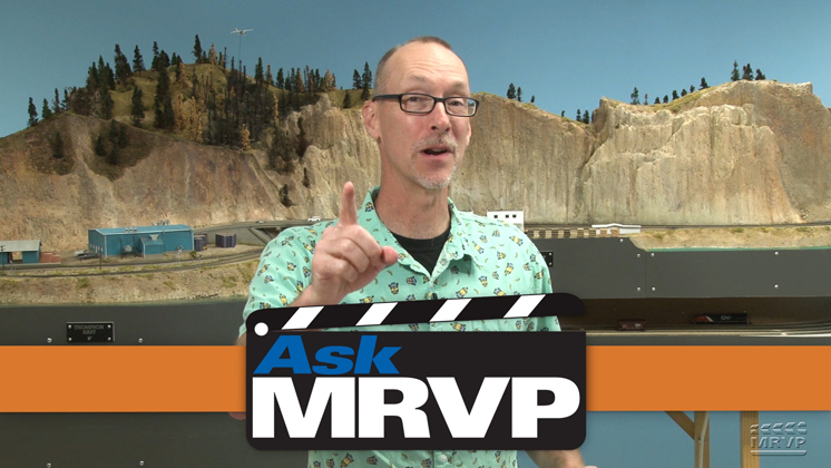 David Popp introduces a video while standing in front of the N scale Canadian Canyons layout.