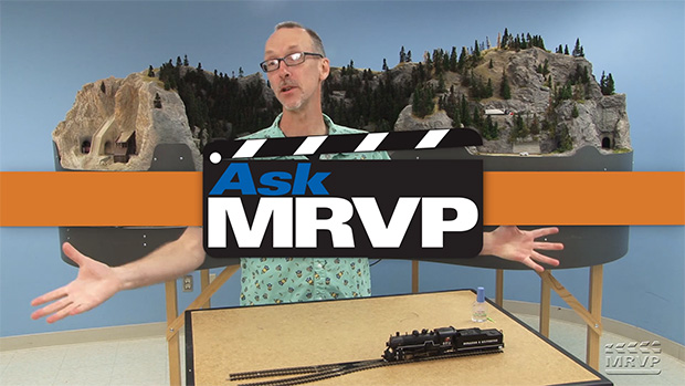 David Popp stands in front of the N scale Canadian Canyons layout project and introduces a video.