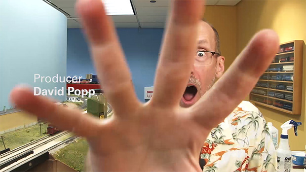 David Popp with a surpised look on his face and his hand reaching toward the camera.