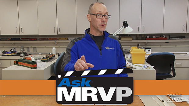 David Popp stands at a counter in the Model Railroader workshop while introducing a video.