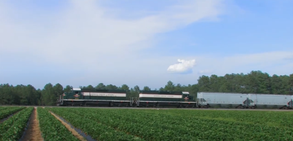 Freight train traveling through farmland