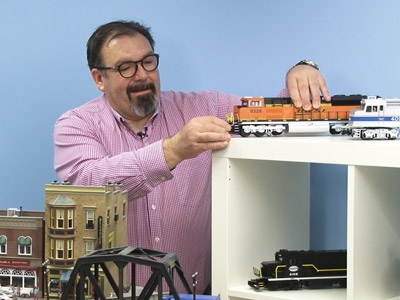 Man Setting up Orange Model Train