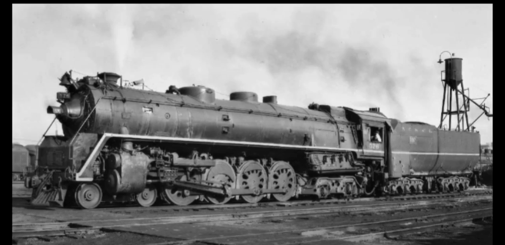 Back and white photo of a steam locomotive and tender