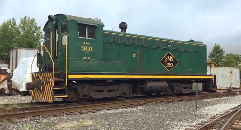 A green-paint switching locomotive in a rail yard.