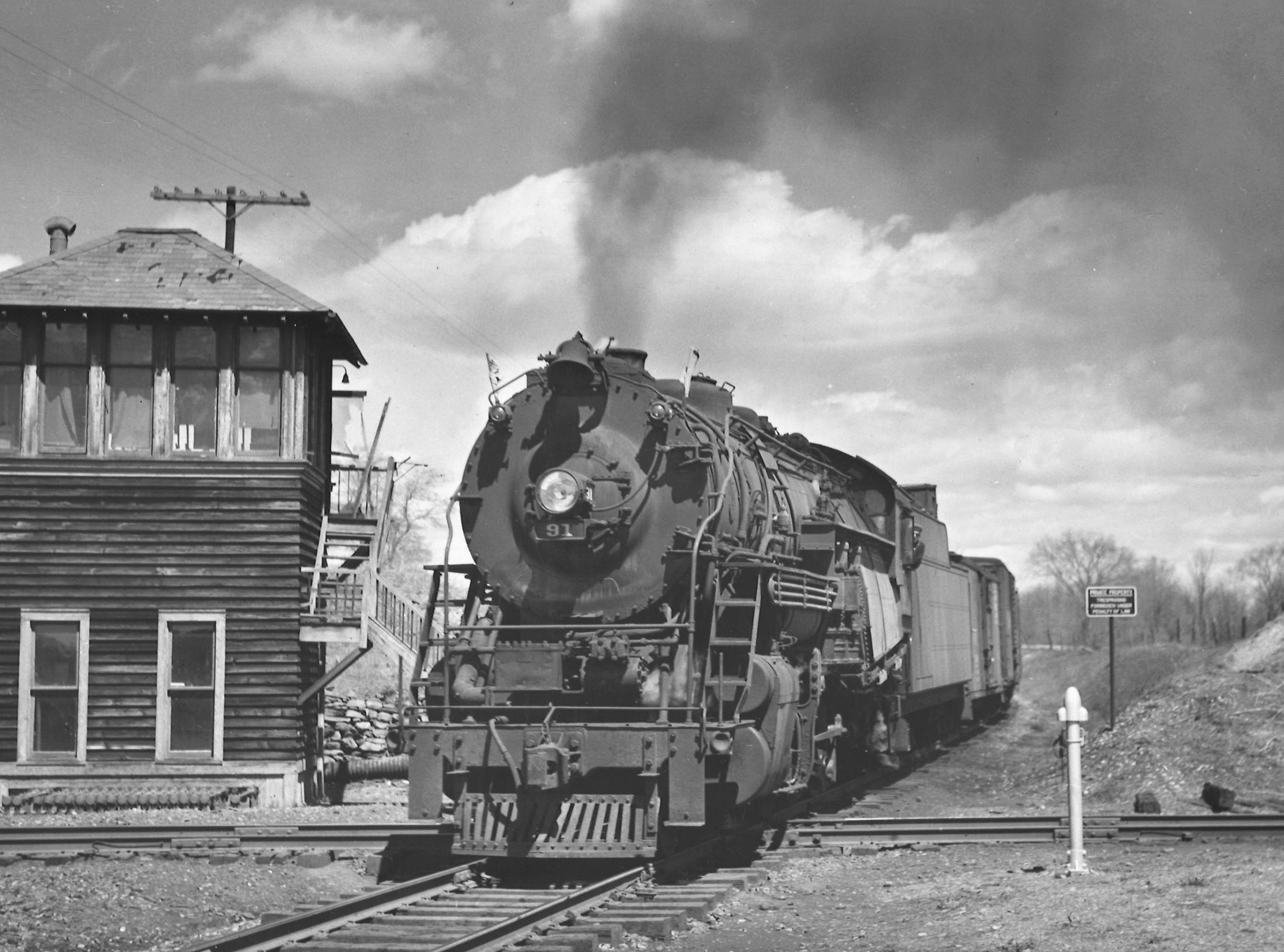Lehigh & Hudson River steam locomotive passing tower with freight train