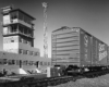 Boxcar in front of modern rail yard office.