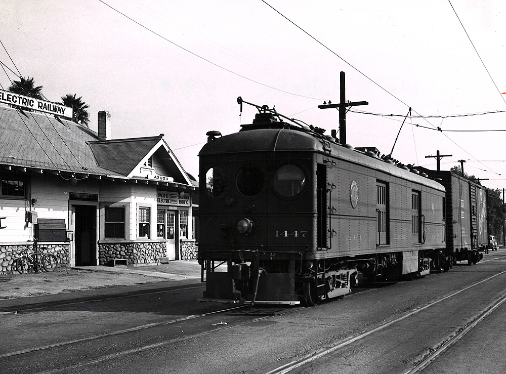 A box motor hauls a one-car freight train.