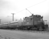 Freight motor hauls three water tank cars.