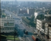 Bird's eye view of two streetcars meeting on a city street in a color photograph.