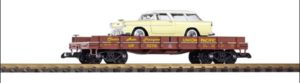 Flatcar carrying a yellow station wagon