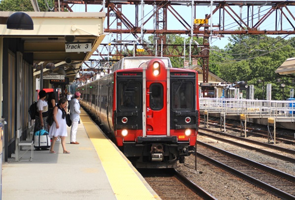 Electric multiple unit trainset with red front stops at station