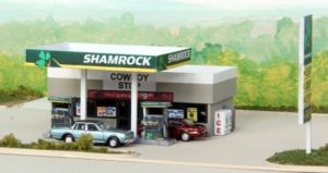 Model gas station with a car parked outside