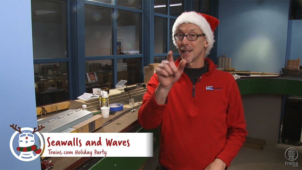 David Popp in santa hat next to HO scale layout