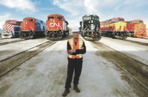 JJ Ruest standing in front of trains