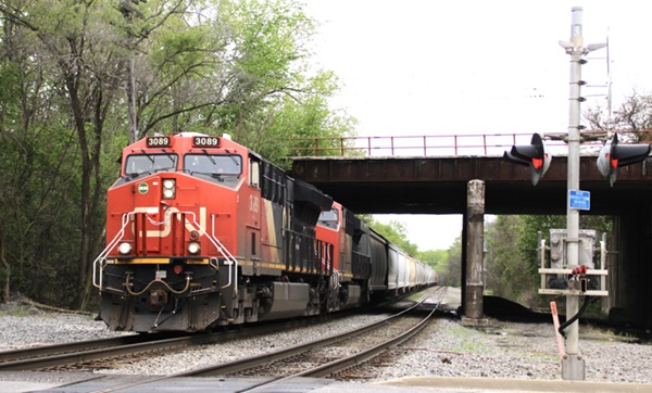 Train traveling under a bridge