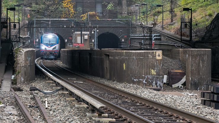 An Amtrak train emerges from the West Portal of the Hudson River tunnels.
