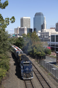 A train passing by a city skyline