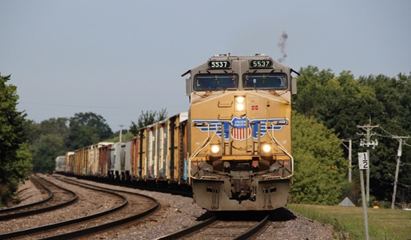 Front view of a train pulling multiple cars