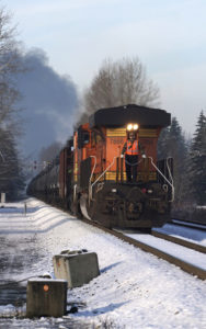 A train going down the tracks in the wintertime