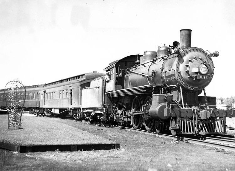 nn Arbor 4-4-2 steam locomotive with passenger train.