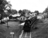 Ann Arbor 4-4-2 steam locomotive with passenger train at station.