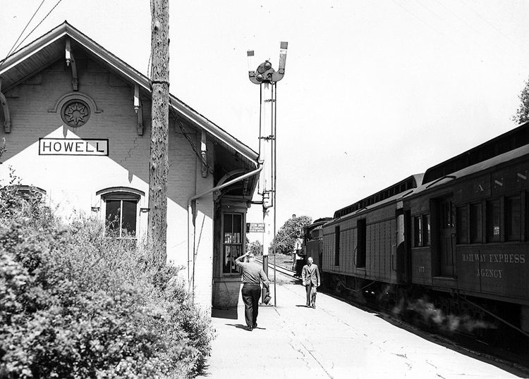 Ann Arbor 4-6-2 steam locomotive with passenger train at station.
