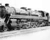 Angled front image of a 4-8-2 steam locomotive.