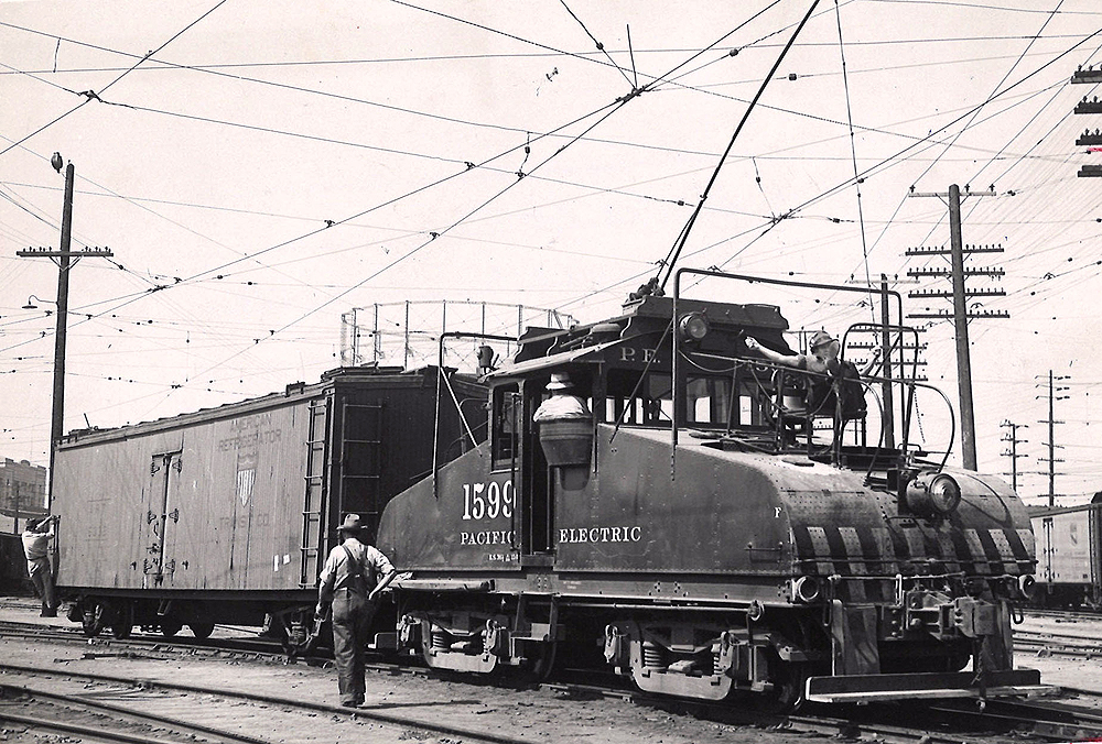 A train crew switches a refrigerated boxcar with a freight motor.
