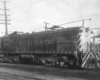 A large diesel locomotive on a multi-track mainline.