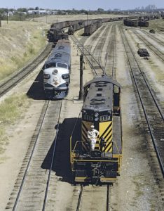 Two diesel locomotives appear in a rail yard.