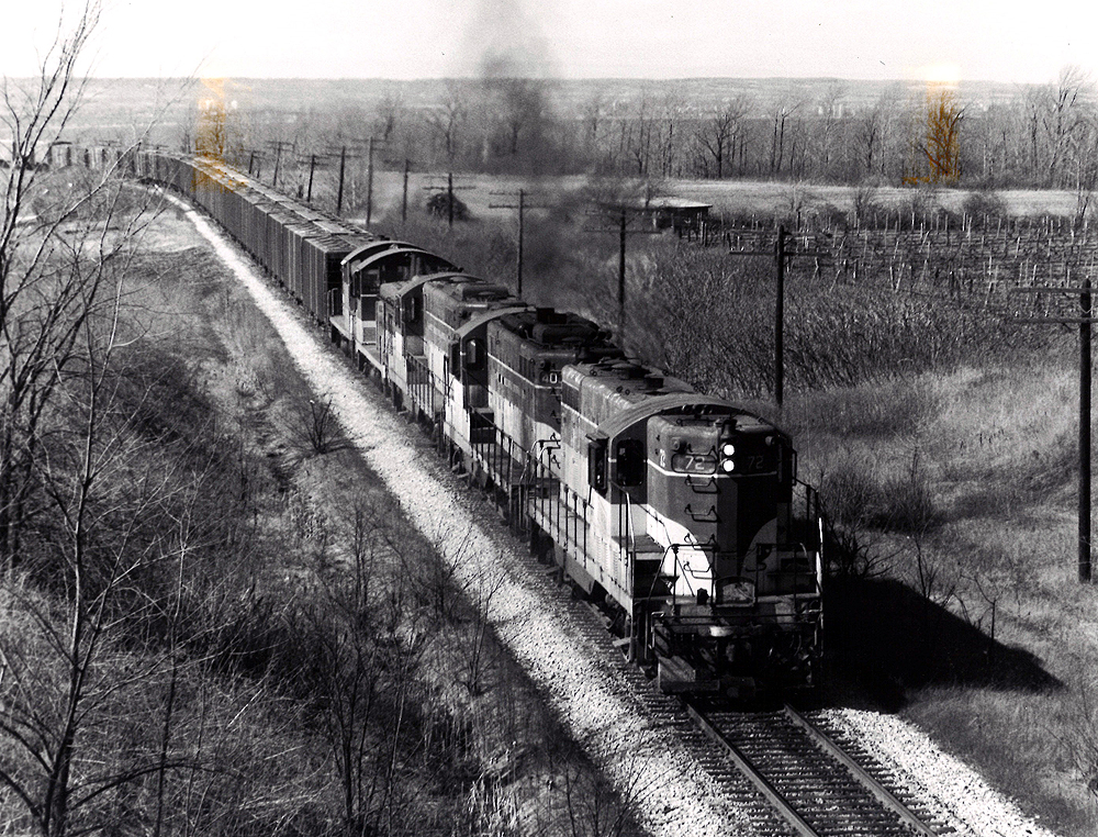 Two Toronto, Hamilton & Buffalo diesel locomotives with freight train.