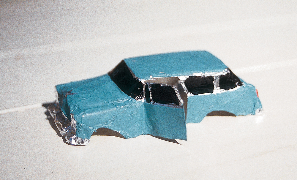 Painted foil model of a station wagon with black windows.