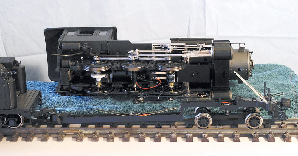 Large-scale model steam locomotive disassembled for lubrication and cleaning.