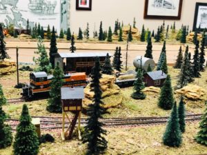 A model train carrying lumber.