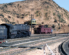 A Santa Fe steam locomotive and caboose are posed at Gary Hoover's HO Scale representation of "Summit", the top of the grade for the Santa Fe in California's Cajon Pass.