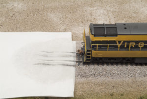 Streaks of dirt from front and rear trucks on paper towel with front of H-16-44 visible at right of frame