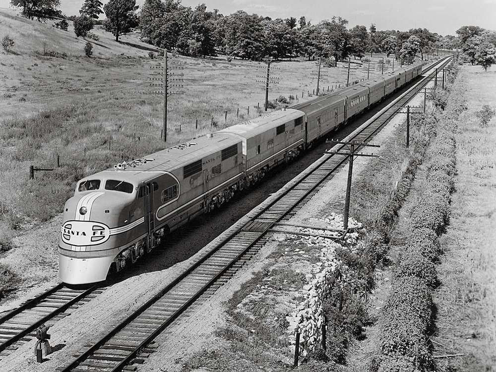 Diesel locomotives with Santa Fe Super Chief passenger train in country