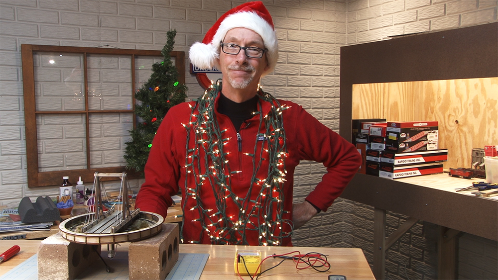 David Popp wearing Christmas lights around his neck and a Santa hat