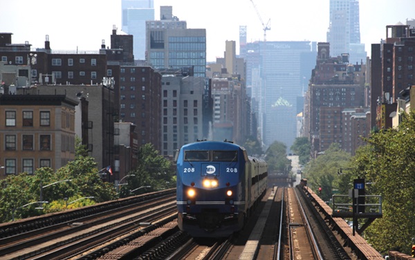 Train driving through the city