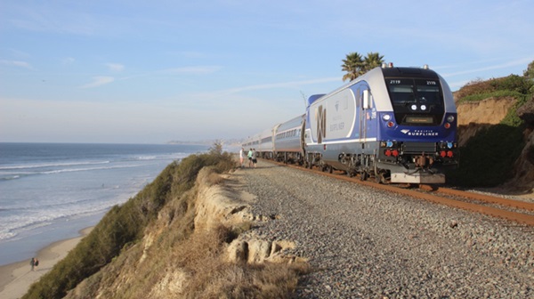 Passenger train next to ocean