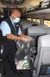 Man collects garbage onboard passenger train