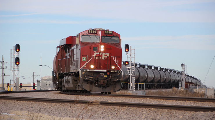 Tank train passing signals on open prairie