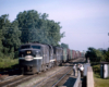 Streamlined and road-switcher diesel locomotives with freight train 