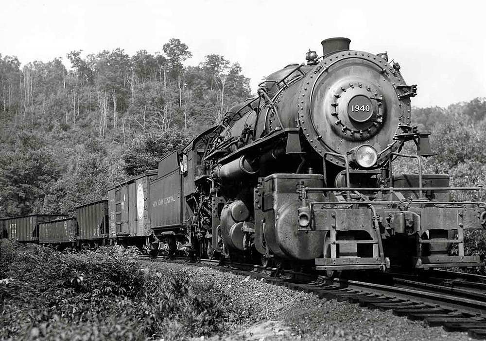 Articulated steam locomotive with freight train