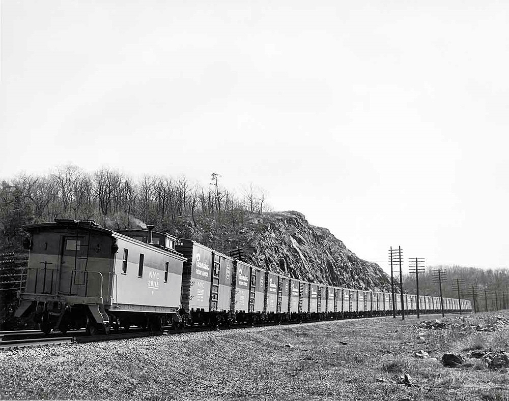Caboose at end of train of special boxcars