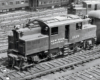 An oblique overhead view of an electric locomotive in a rail yard.